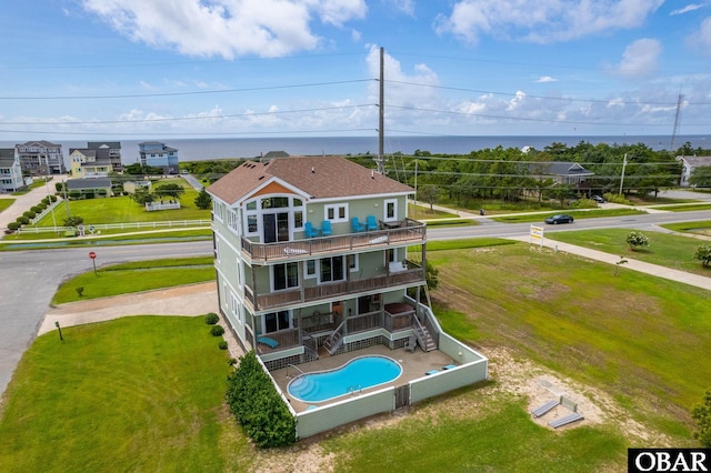 back of house with a water view and a balcony