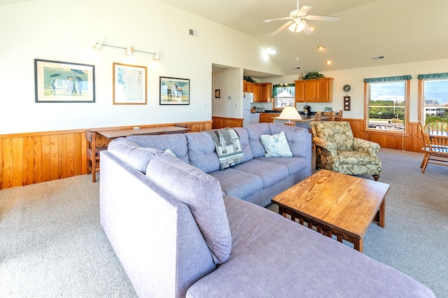 25253 Bold Dune Dr Lot 11, Waves, NC 27968 - carpeted living room featuring wainscoting, wood walls, a ceiling fan, and lofted ceiling