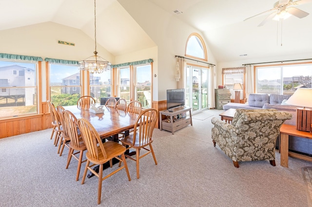 25253 Bold Dune Dr Lot 11, Waves, NC 27968 - dining space featuring light colored carpet, wainscoting, a chandelier, wood walls, and high vaulted ceiling