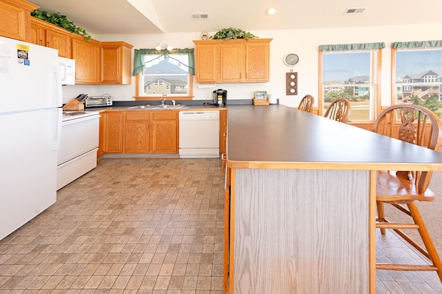 25253 Bold Dune Dr Lot 11, Waves, NC 27968 - kitchen featuring white appliances, a peninsula, a sink, healthy amount of natural light, and recessed lighting