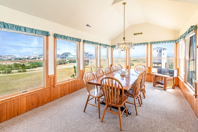 25253 Bold Dune Dr Lot 11, Waves, NC 27968 - sunroom with carpet floors, a chandelier, lofted ceiling, wooden walls, and wainscoting