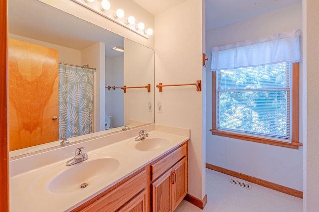 25253 Bold Dune Dr Lot 11, Waves, NC 27968 - bathroom featuring toilet, double vanity, baseboards, and a shower with shower curtain