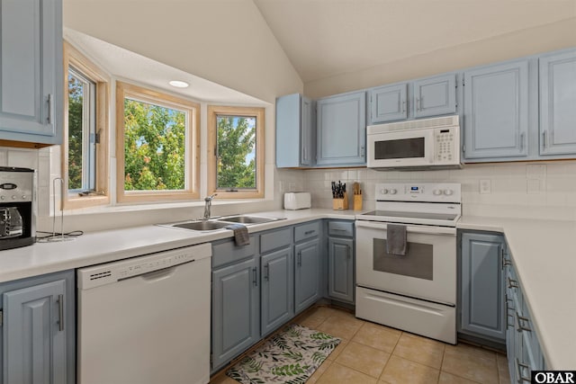 1039 Miller Ct Lot 526, Corolla, NC 27927 - kitchen featuring white appliances, a sink, gray cabinets, vaulted ceiling, and backsplash