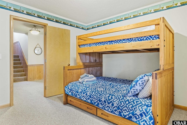 1039 Miller Ct Lot 526, Corolla, NC 27927 - bedroom with carpet floors, a textured ceiling, and wood walls