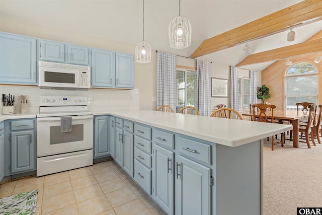 1039 Miller Ct Lot 526, Corolla, NC 27927 - kitchen with white appliances, a peninsula, light countertops, wooden walls, and blue cabinets