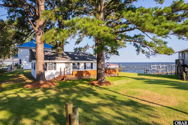 view of yard with a boat dock and a deck with water view