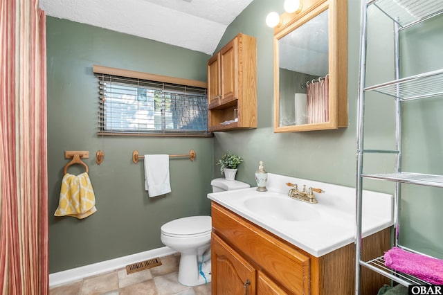 full bathroom with a textured ceiling, toilet, vanity, visible vents, and baseboards