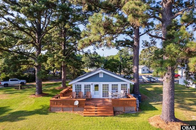 rear view of house featuring a deck and a yard