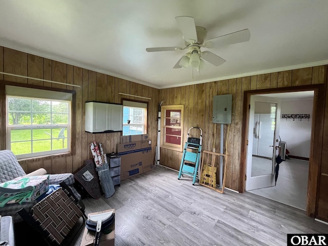 2253 Turnpike Rd, Swan Quarter, NC 27885 - living area featuring electric panel, wood walls, crown molding, ceiling fan, and light wood-style floors