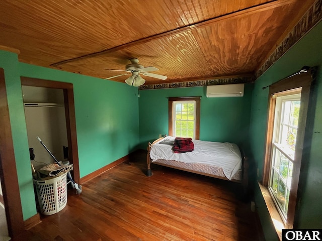 2253 Turnpike Rd, Swan Quarter, NC 27885 - bedroom with a wall unit AC, wood ceiling, wood finished floors, and ceiling fan