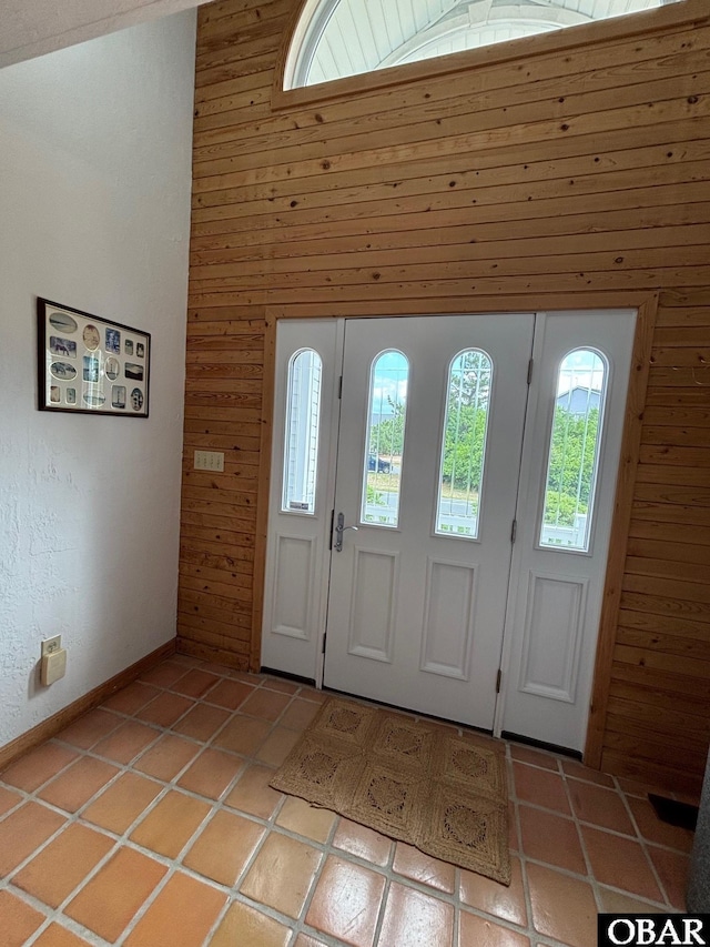 114 Poteskeet Dr Lot 66, Kitty Hawk, NC 27949 - entrance foyer featuring wooden walls, light tile patterned floors, and a towering ceiling