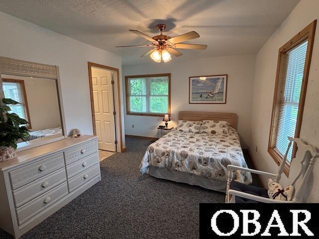 114 Poteskeet Dr Lot 66, Kitty Hawk, NC 27949 - bedroom with carpet floors, a ceiling fan, and baseboards