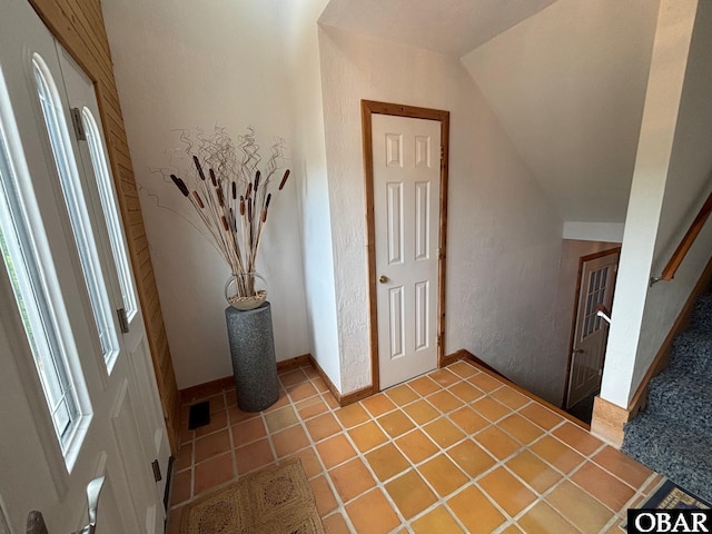 114 Poteskeet Dr Lot 66, Kitty Hawk, NC 27949 - entryway featuring vaulted ceiling, baseboards, stairway, a textured wall, and light tile patterned floors