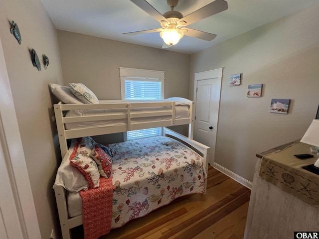 74 Lake Dr, Ocracoke, NC 27960 - bedroom with wood finished floors and a ceiling fan