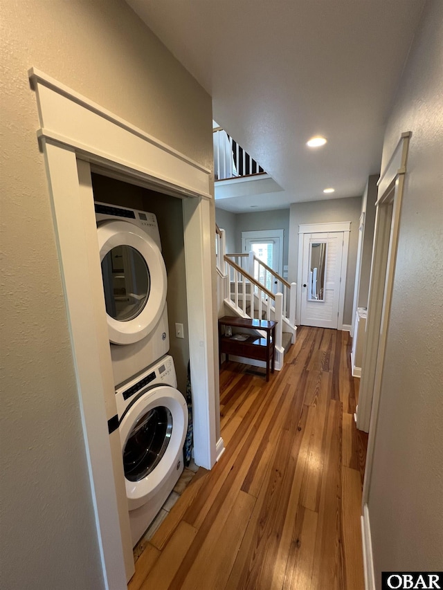 74 Lake Dr, Ocracoke, NC 27960 - laundry room featuring stacked washing machine and dryer, hardwood / wood-style flooring, and recessed lighting