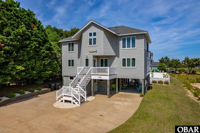 4705 Summer Ln Lot 2, Kitty Hawk, NC 27949 - back of house with a lawn, a carport, a shingled roof, stairway, and driveway
