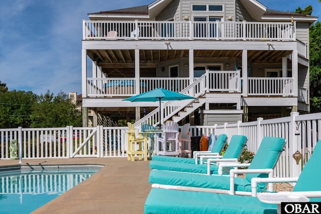 4705 Summer Ln Lot 2, Kitty Hawk, NC 27949 - rear view of property with a balcony, a fenced in pool, fence, stairs, and a wooden deck