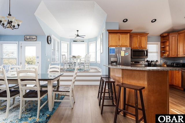 567 Ocean Trl Lot 140, Corolla, NC 27927 - kitchen with appliances with stainless steel finishes, brown cabinets, open shelves, and a kitchen island