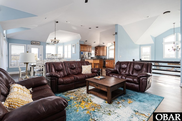 567 Ocean Trl Lot 140, Corolla, NC 27927 - living room featuring a chandelier, lofted ceiling, and wood finished floors