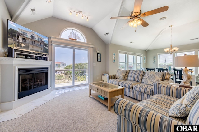 carpeted living room featuring plenty of natural light, a fireplace with flush hearth, and visible vents