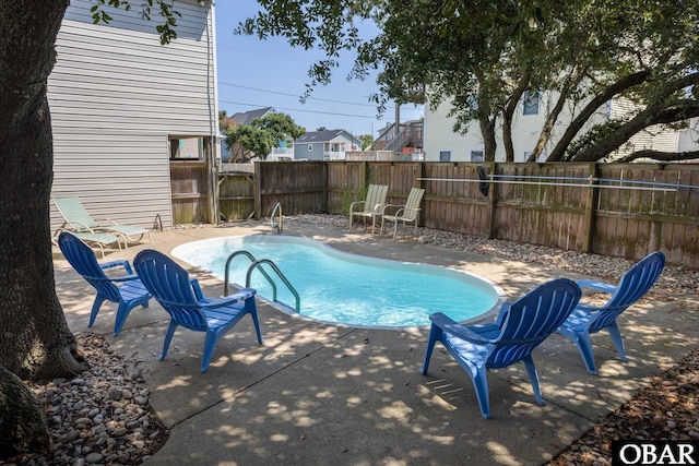 view of swimming pool featuring a fenced backyard, a fenced in pool, and a patio