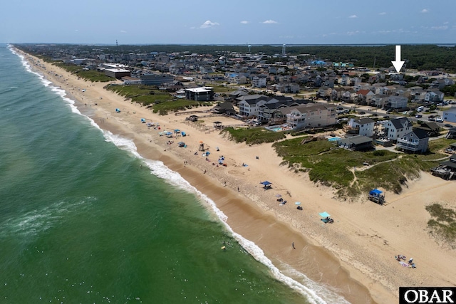 drone / aerial view featuring a view of the beach and a water view