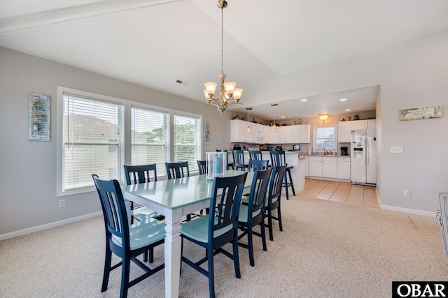 dining area with a notable chandelier, light colored carpet, visible vents, vaulted ceiling, and baseboards