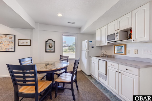 dining space with baseboards, visible vents, a textured ceiling, and recessed lighting