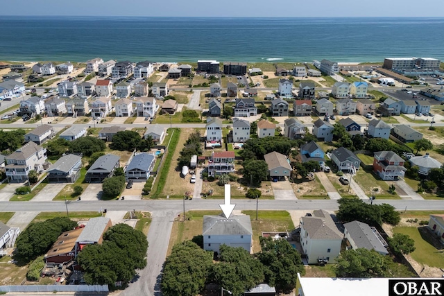 drone / aerial view featuring a residential view and a water view