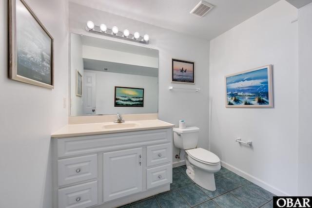 bathroom with visible vents, toilet, vanity, tile patterned flooring, and baseboards