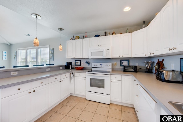 kitchen with white appliances, light tile patterned floors, white cabinets, decorative light fixtures, and light countertops