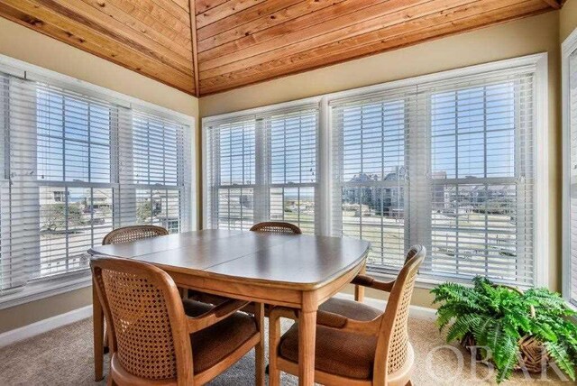 dining space with wooden ceiling, carpet, and baseboards