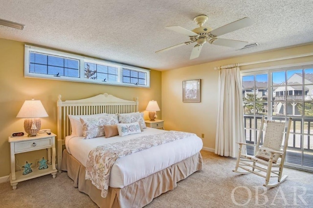 bedroom with access to exterior, visible vents, a textured ceiling, and light colored carpet