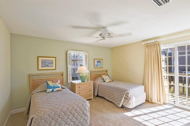 bedroom featuring light carpet, baseboards, visible vents, a ceiling fan, and access to exterior