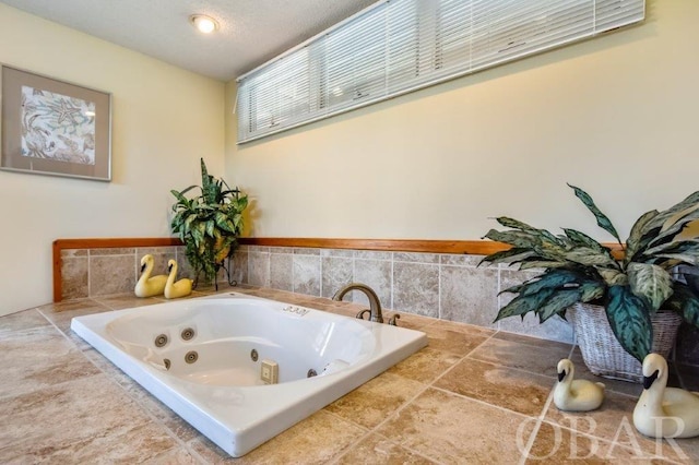 bathroom with a tub with jets