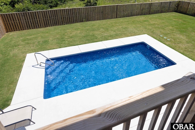 view of pool featuring a yard and a fenced backyard