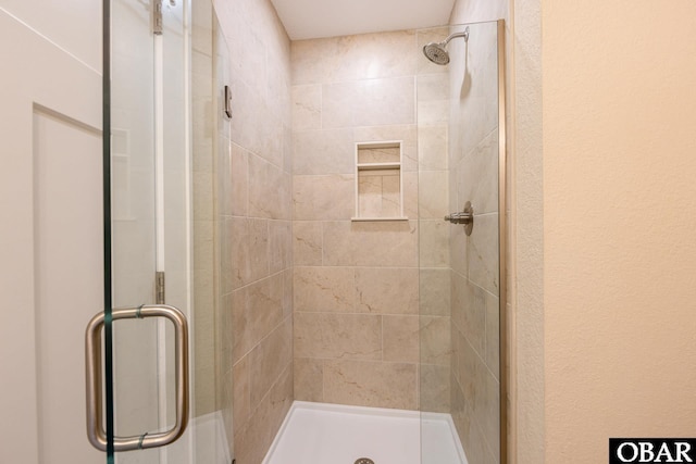 full bath featuring a shower stall