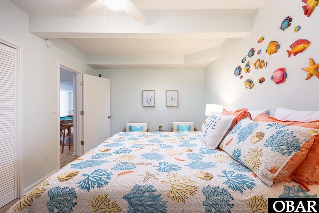 bedroom featuring baseboards, a closet, a ceiling fan, and beam ceiling