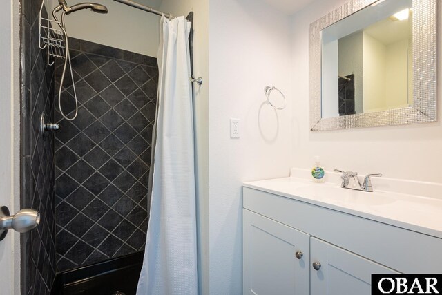 full bathroom featuring a stall shower and vanity