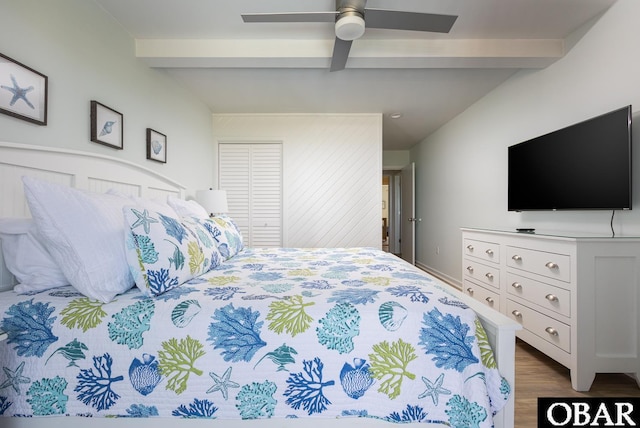 bedroom with lofted ceiling with beams, dark wood finished floors, and a ceiling fan