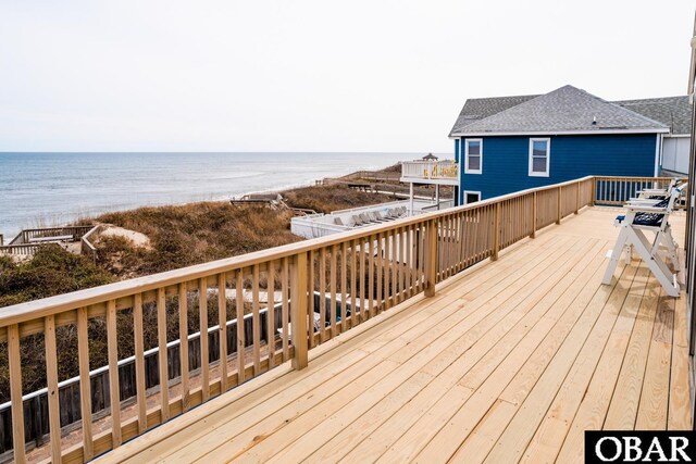 wooden deck featuring a water view