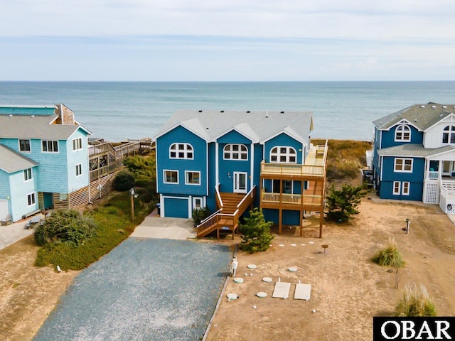 birds eye view of property featuring a water view and a view of the beach