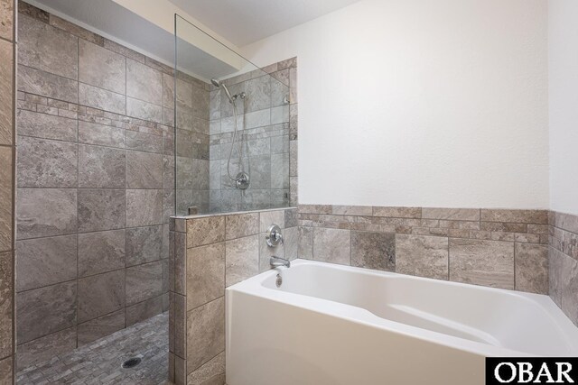 bathroom featuring a garden tub and walk in shower