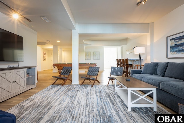 living area featuring light wood-type flooring, pool table, and visible vents