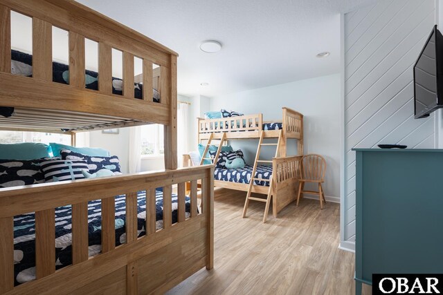 bedroom featuring light wood-type flooring and baseboards