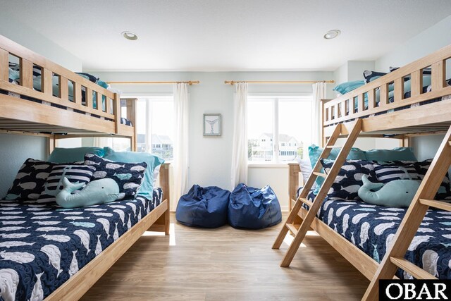 bedroom with multiple windows, wood finished floors, and recessed lighting