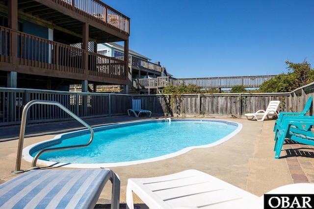 view of swimming pool with a fenced in pool, a patio area, and fence