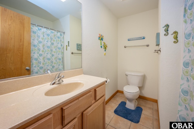 full bathroom with vanity, baseboards, tile patterned floors, and toilet