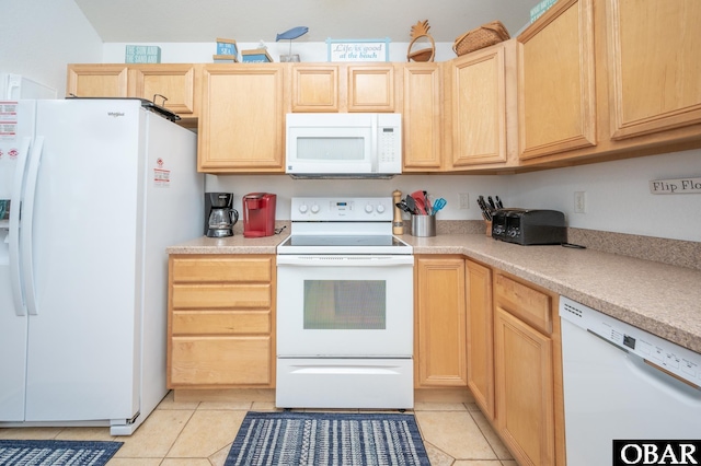 kitchen with light countertops, light tile patterned floors, light brown cabinets, and white appliances