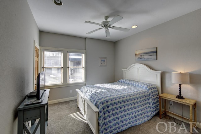 bedroom with ceiling fan, carpet flooring, and baseboards